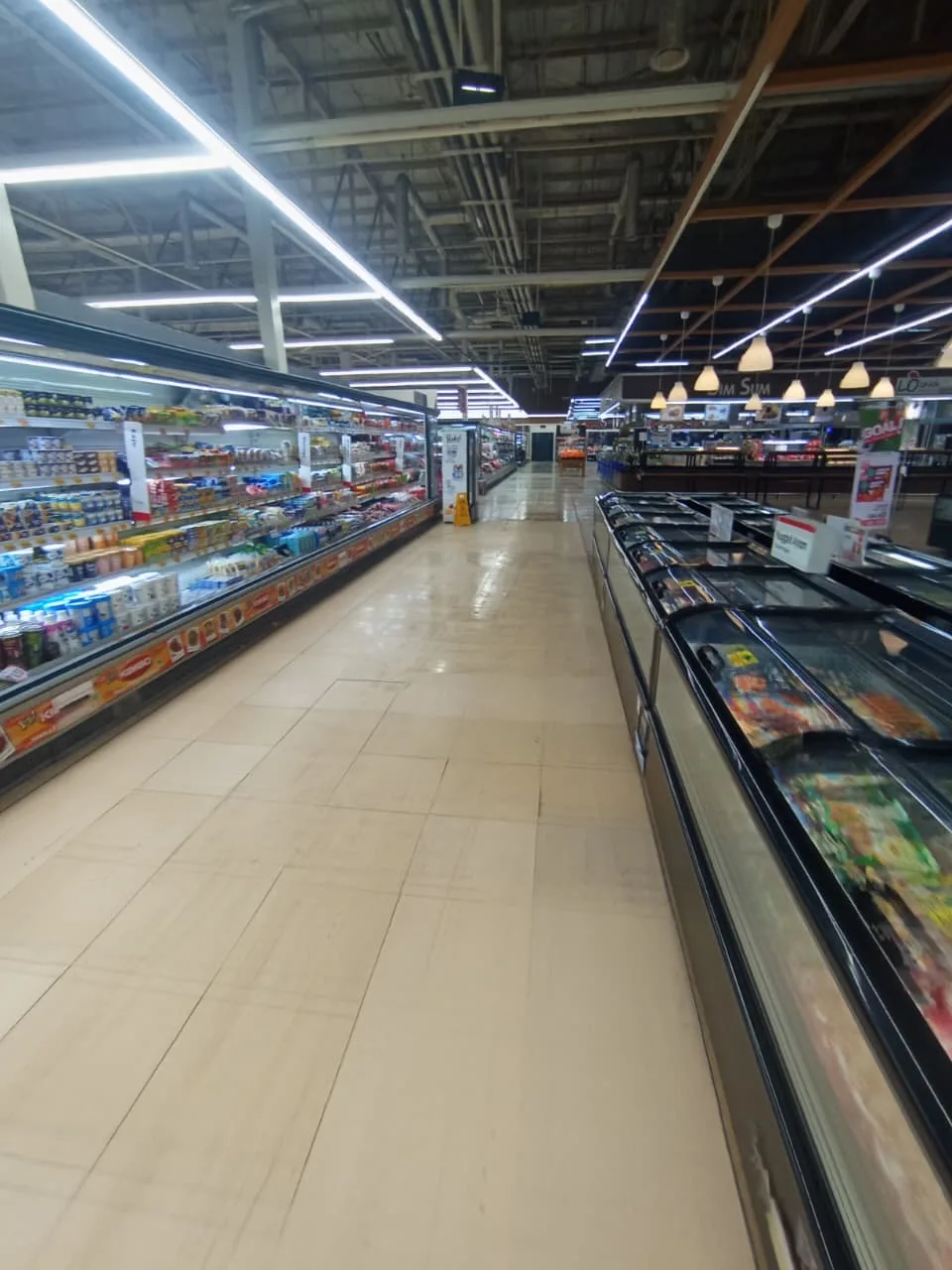 Refrigerated display cabinets stocked in a retail store